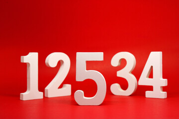 Counting numbers ( 1 2 3 4 5 ) white number wooden on Red Background with Copy Space - One Two Three Four Five 
