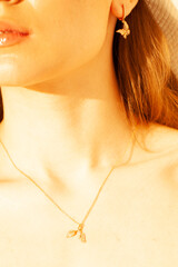 Beautiful gold jewelry on a girl close-up.