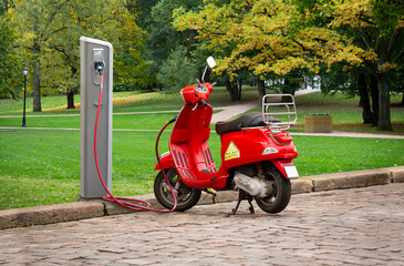 Electric scooter with charging station on a city street	