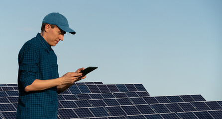 Engeneer with tablet computer on a background of solar energy power station