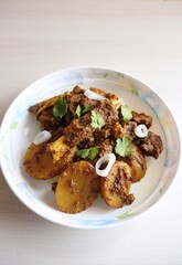 Mutton ghee roast. Goat meat fry with potatoes, also known as Mutton Batata bhujing. Spicy non-vegetarian lamb fry dish. Mutton curry or mutton fry. copy space.