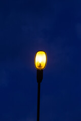 Street light pole on dark blue sky background at during the night. Coppy space