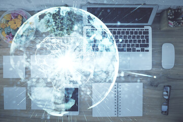 Business theme hologram drawings over computer on the desktop background. Top view. Multi exposure. Concept of international connections.