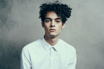 man in white shirt curly hair emotions studio modern style