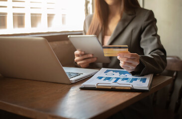 Women hold credit cards, conduct financial transactions via tablets and data documents, put on the...