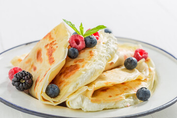 Pancakes with cottage cheese, berries and sugar. Pancakes for breakfast.