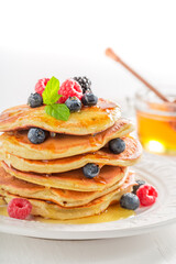 American pancakes served with honey and berries. Pancakes for breakfast.