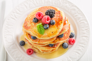 American pancakes with blueberries and raspberries. Pancakes for breakfast.