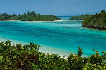 Impressive pristine scenery of Kabira Bay with its crystal clear turquoise waters, where its flows in the midst of a channel of vegetation. Incredible scene seen from above.