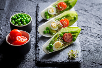Salad in chicory with egg and tomato. Custom salad decomposition.