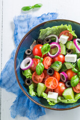 Homemade Greek salad with lettuce, cherry tomatoes and onion.