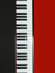Top view of piano keyboard on red background