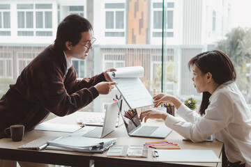 Asian businessman presenting a work plan The description of the results of the work businesswoman...