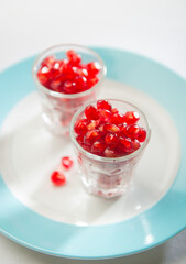 Fresh, Juicy and very nutritious pomegranate seeds served in a tiny shot glass. Raw, natural and healthy fruit diet for good health.