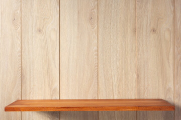 Naklejka na ściany i meble Wooden shelf at wooden wall background texture. Book shelf on wall