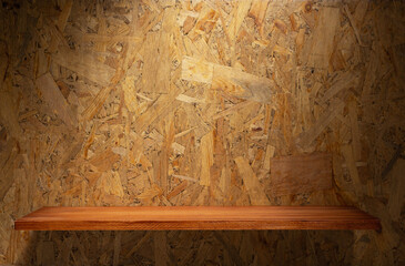 Wooden shelf and osb wood background of wall texture. Book shelf at chipboard background © Sergii Moscaliuk