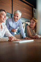 Obraz premium Senior female colleagues giving a support to their young female colleague at the workplace. Business, office, job