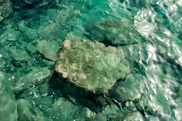 Aquamarine sea water and underwater stones