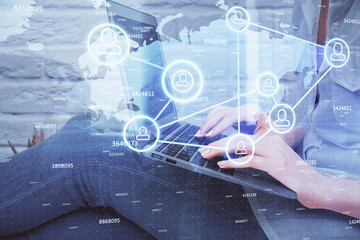 Double exposure of woman hands typing on computer and social network theme hologram drawing. People media concept.