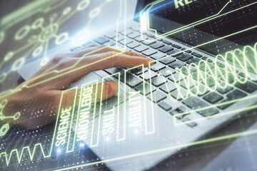Double exposure of woman hands typing on computer and general theme hologram drawing. Education concept.