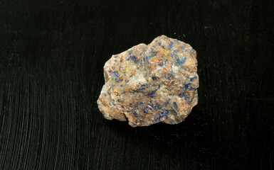 Azurite chessylite from Morocco. Natural mineral stone on black background. Mineralogy, geology, magic of stones, semi-precious stones and samples of minerals. Close-up macro photo.