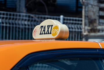 Taxi sign on top of a car, close up.