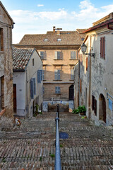 A narrow street between the old houses of Civitanova Alta, a medieval town in the Marche region of Italy.