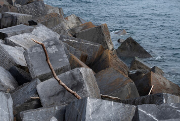 pile of breakwater stones on the coast