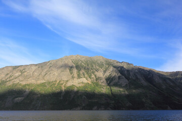 incredible view on lake called windy arm, and surrounding mountains in canadian wilderness, path...