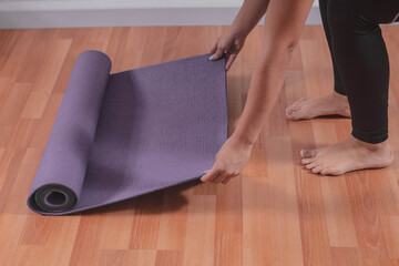 Young woman with a yoga mat