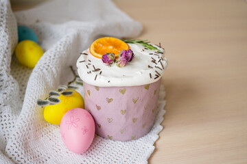 Glazed easter cake decorated with oranges and eggs on wooden table. Happy Easter Holidays