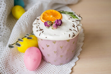 Glazed easter cake decorated with oranges and eggs on wooden table. Happy Easter Holidays