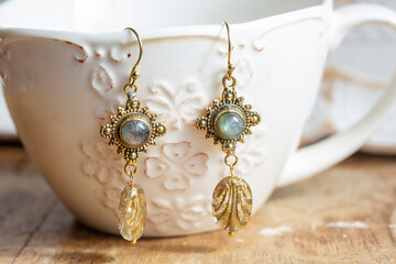 brass labradorite stone earrings on white cup background - 426831888