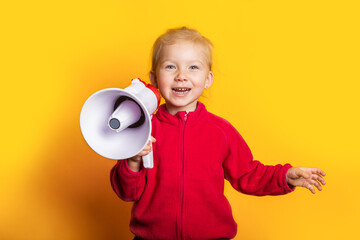 smiling girl holding a megaphone on a bright yellow background.