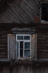 Naklejka na ściany i meble The window of an old wooden house. A window with shutters..