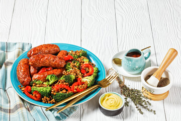 Italian sausages with lentils on a plate, top view