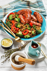 Italian sausages with lentils on a plate, top view