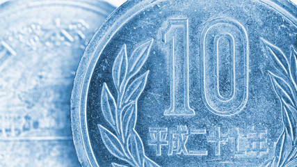Translation: Japan 2015. Japanese coin of 10 yen close-up. Light blue tinted illustration. Background or backdrop about money, economy, finance, taxes and financial management. Macro