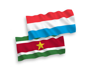 Flags of Republic of Suriname and Luxembourg on a white background