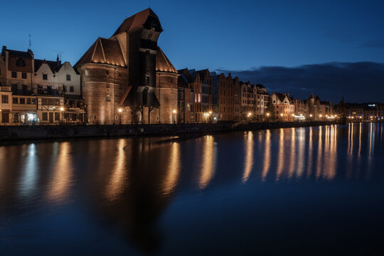 Night view of the Gdańsk town with the old port crane by the Motława river, Poland.