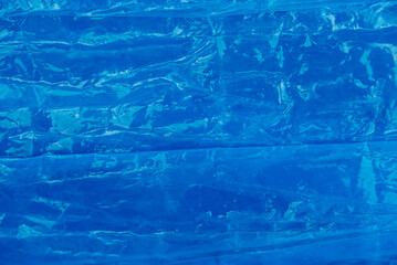 Blue crumpled plastic wrap as a background texture. Copy, empty space for text