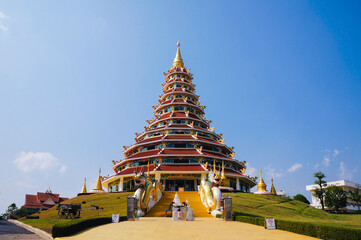 Wat Huay Pla Kang Temple, Beautifully with high stupa and elegance blue sky in the background. Located in Chiang Rai, Thailand.