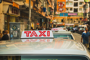 Row of Taxi cab cars waiting in Hong Kong