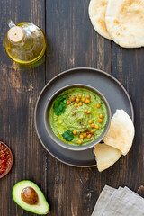Avocado hummus in a gray bowl. Healthy eating. Vegetarian food.