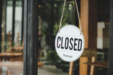 Closed. coffee cafe text on vintage sign board hanging on glass door in modern cafe coffee shop,...