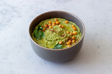 Avocado hummus in a gray bowl. Healthy eating. Vegetarian food.