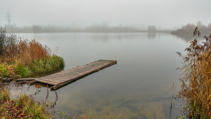 Foggy morning by the lake in autumn