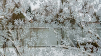 Frost on the glass of the window, winter background
