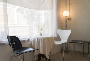 White and black table and chairs and minimalist floor lamp