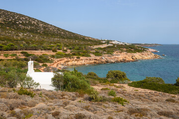 The beautiful coast of Antiparos Island with a white Greek chapel on a hill. Cyclades, Greece